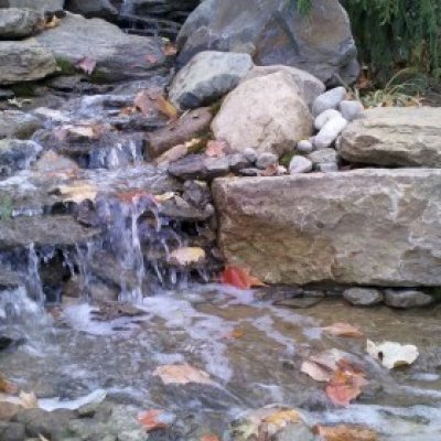 Pondless waterfall, stream with granite boulders and native flat rock.