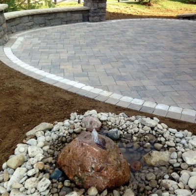Custom Bubbling Boulder With Pavor Patio and Seat Wall